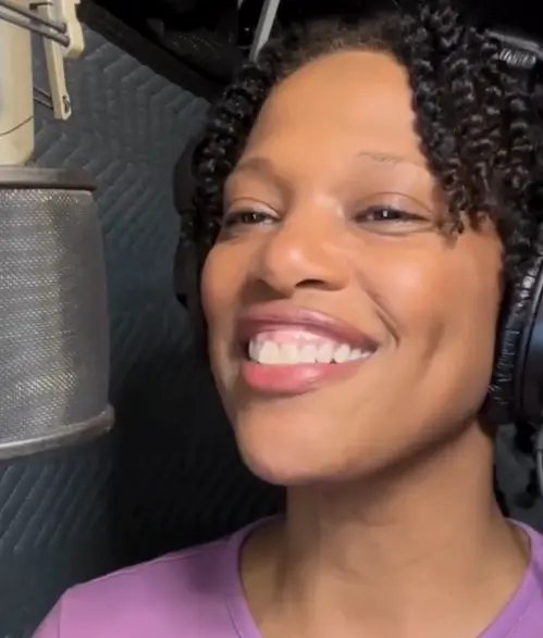 Soraya Butler voicing a sports promo in her voiceover booth